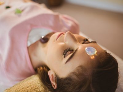 Young woman at crystal healing session in therapy room